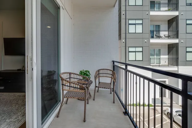 a view of a patio with dining table and chairs