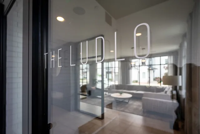 a living room with furniture and large windows