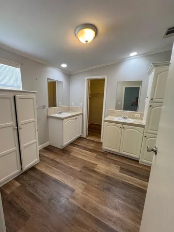 a kitchen with a sink a refrigerator and a stove top oven