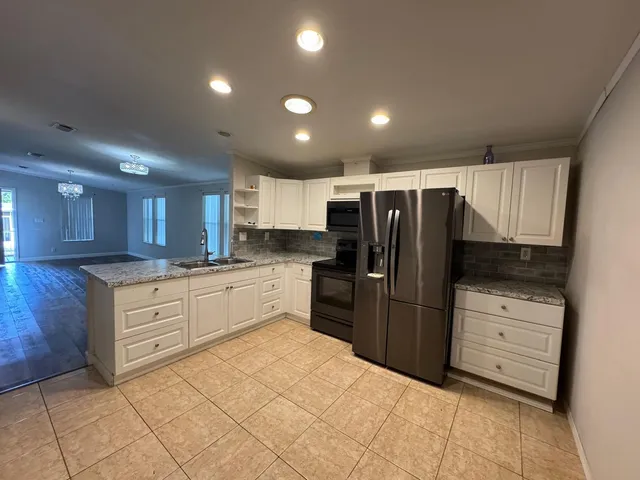 a kitchen with granite countertop cabinets and stainless steel appliances