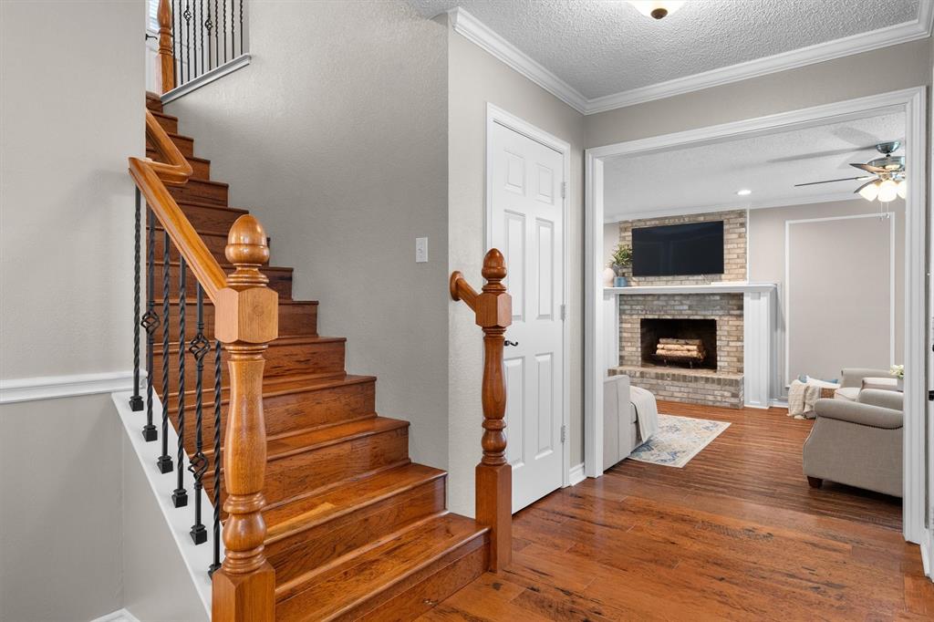 410 Simmons Road Double Oak, TX 75077 - Photo 8 of 40 Rich hardwood floors and a graceful staircase set the tone for quality throughout.