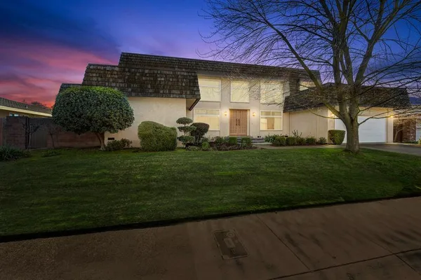 a front view of a house with a garden