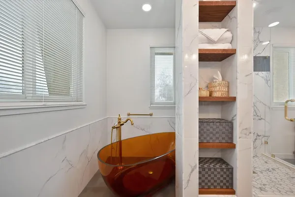 a bathroom with a sink mirror and a tub