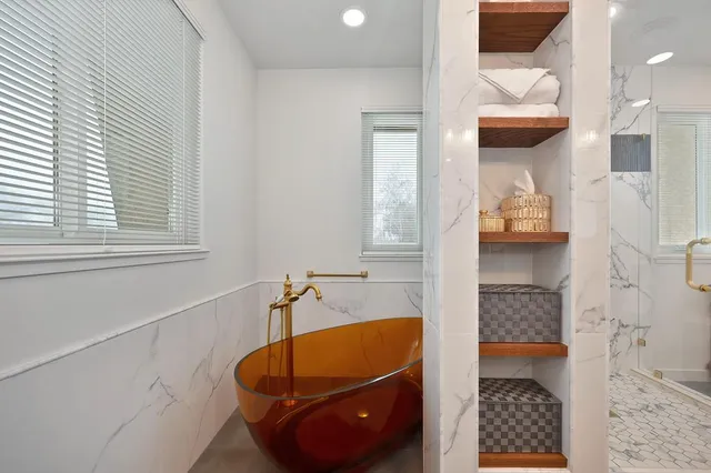a bathroom with a sink mirror and a tub