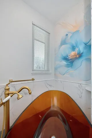 a view of a garden with a bench in front of the house