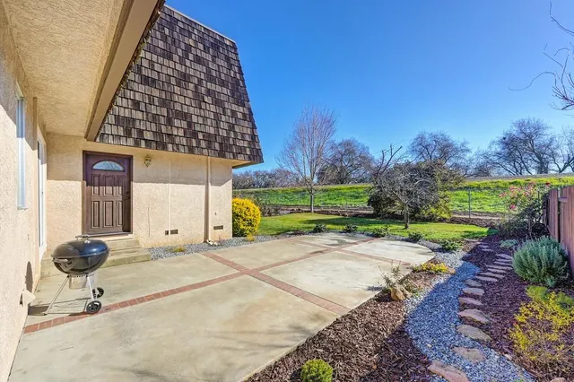 a view of a patio with table and chairs and potted plants