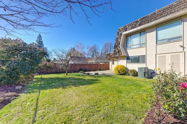 a view of yard with swimming pool and green space