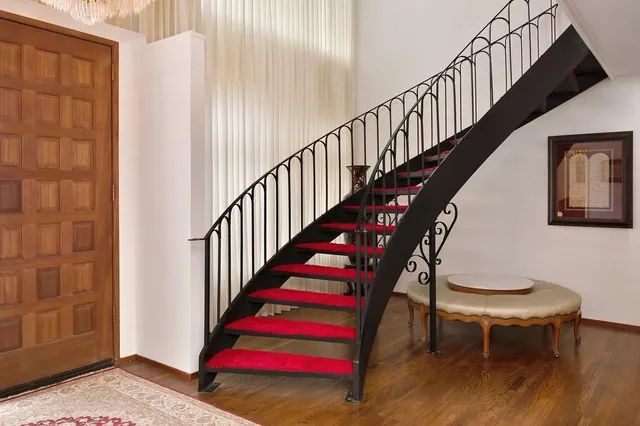 a living room with furniture a fireplace and a chandelier