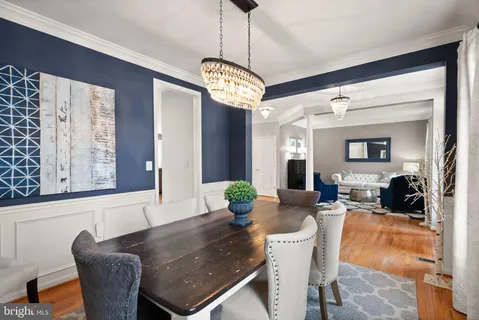 a living room with furniture wooden floor and a large window