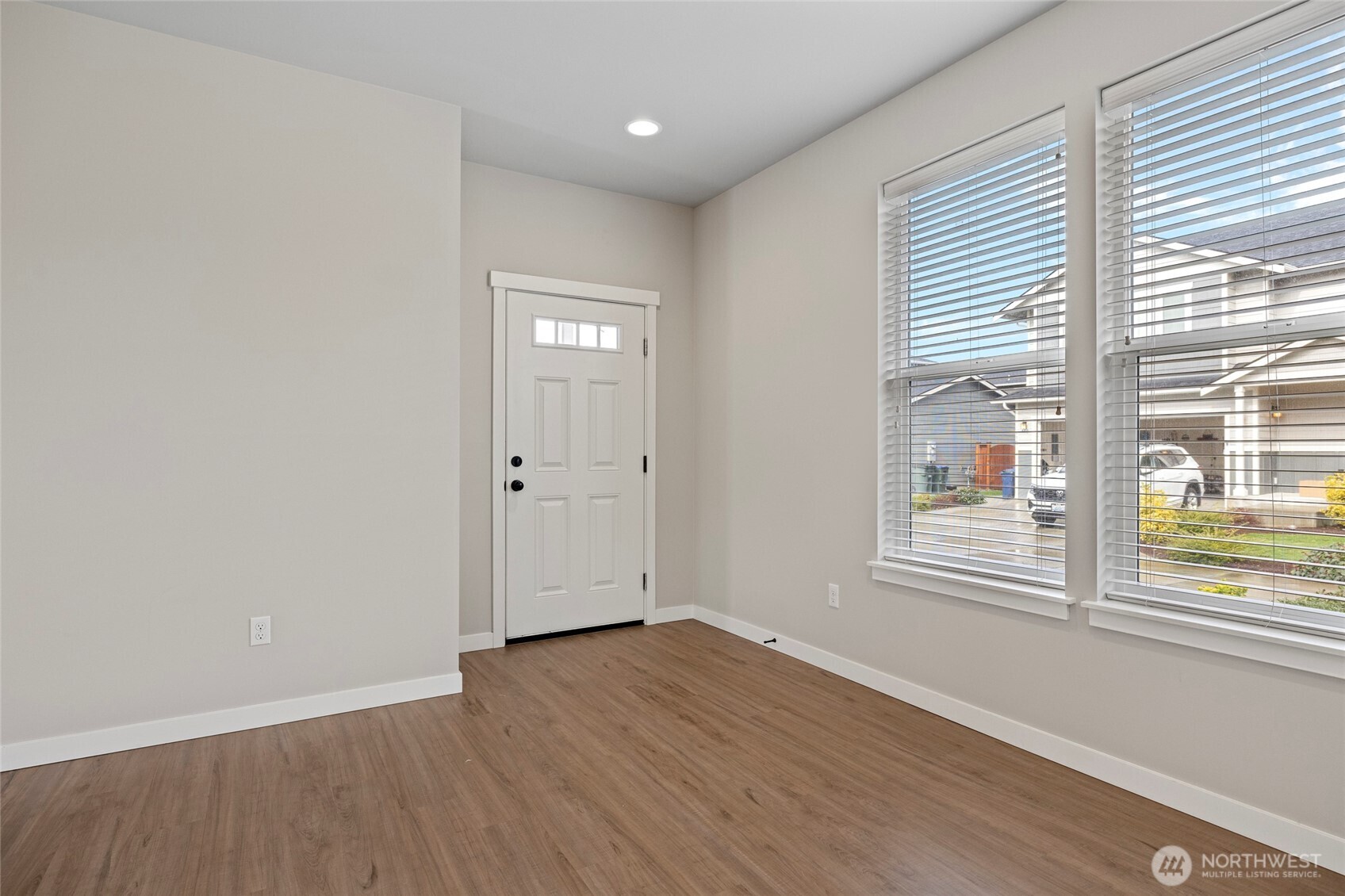 122 North Trl Road Sedro-Woolley, WA 98284 - Photo 3 of 40 a view of an empty room with wooden floor and a window