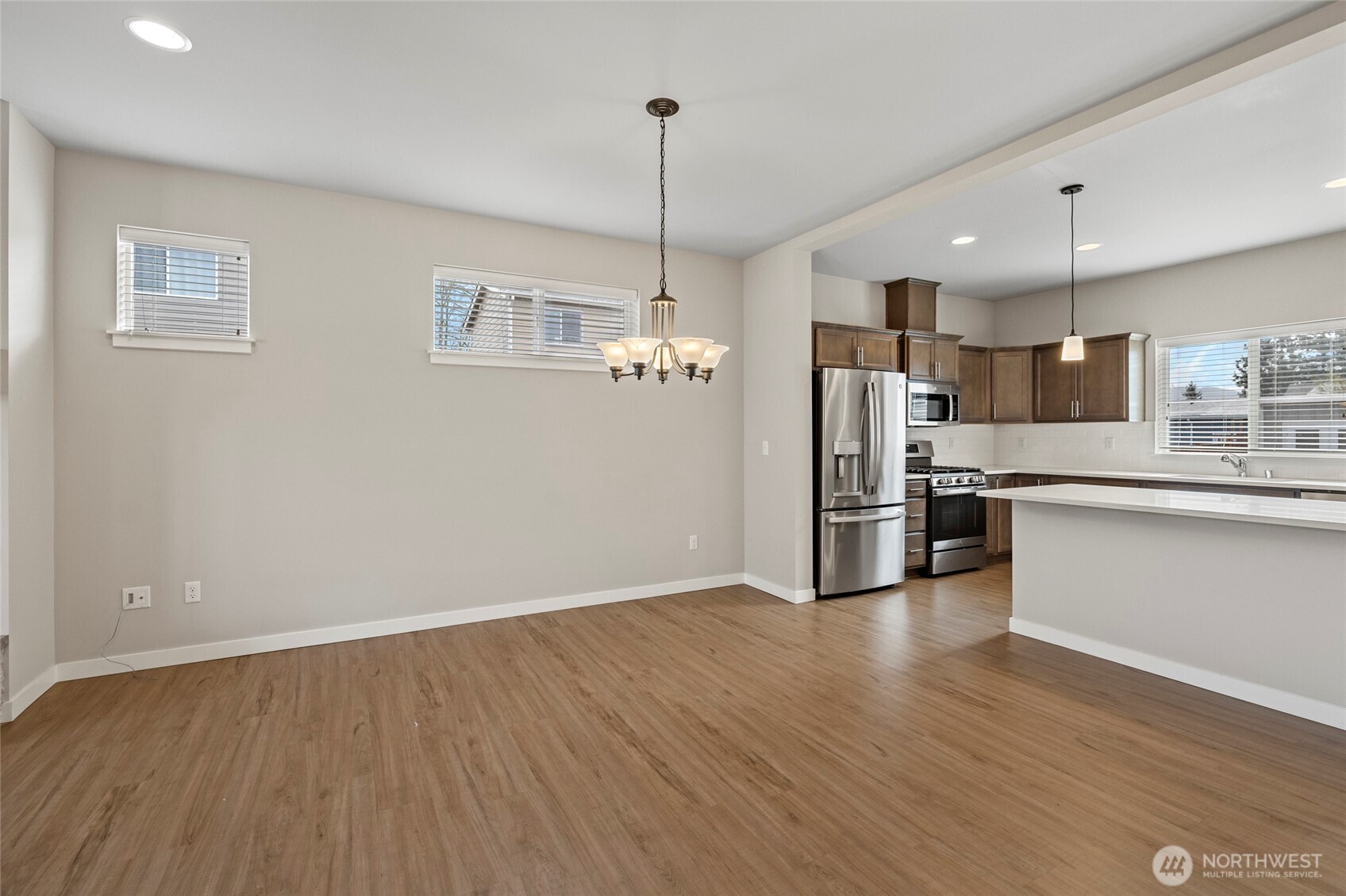 122 North Trl Road Sedro-Woolley, WA 98284 - Photo 9 of 40 a kitchen with stainless steel appliances granite countertop a refrigerator a sink dishwasher a stove and white countertops with wooden floor