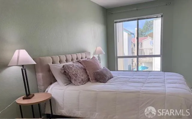 a bedroom with a bed and a window