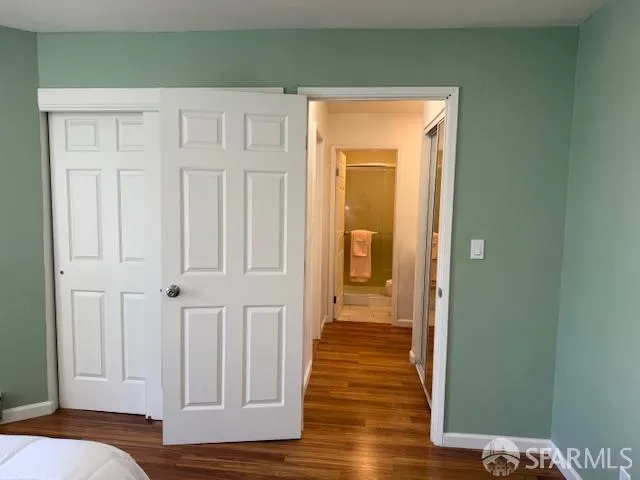 a view of a room with wooden floor