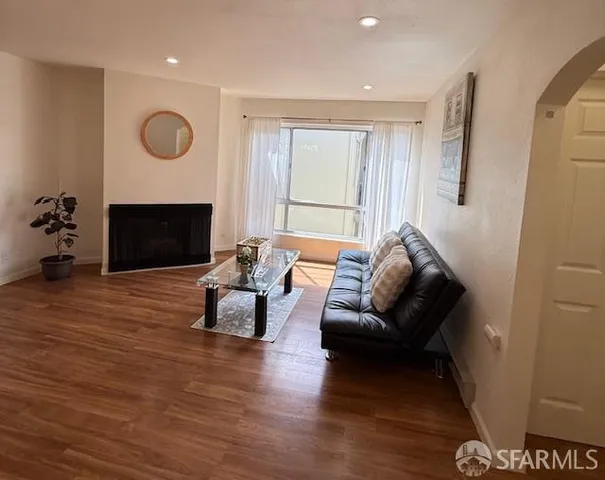 a living room with furniture or fireplace and a wooden floor