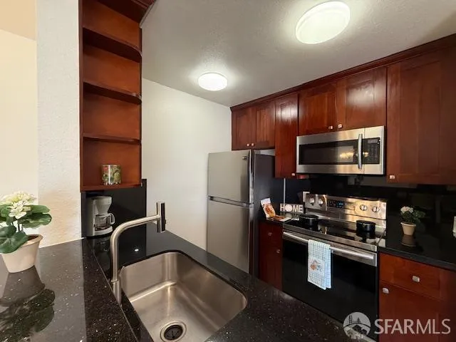 a kitchen with a refrigerator and a sink