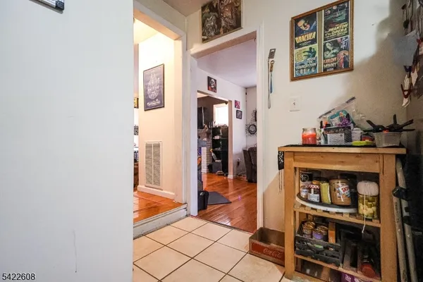 a view of a hallway with wooden floor and furniture
