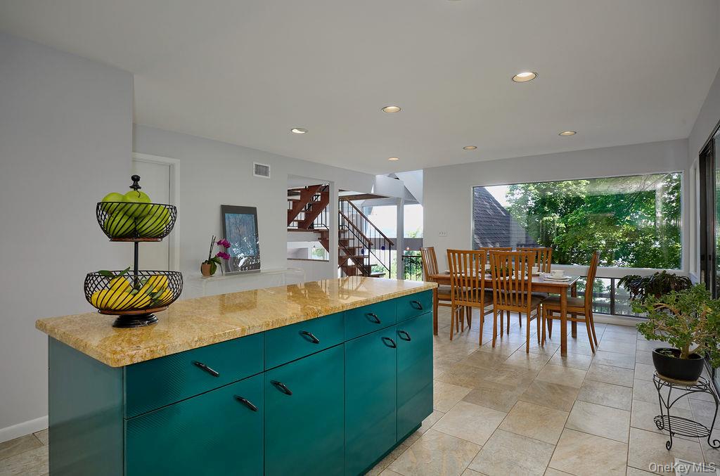 273 River Road Nyack, NY 10960 - Photo 15 of 48 Open-concept living area featuring a kitchen island with stone countertop, recessed lighting, tile flooring, and large windows