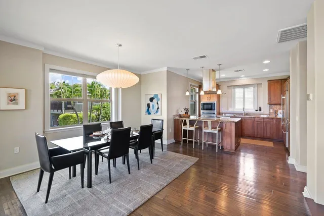 a kitchen with kitchen island granite countertop a sink counter top space appliances and cabinets