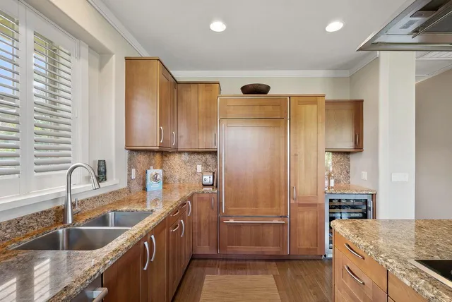 a kitchen with sink stove and cabinets