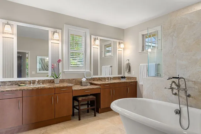 a bathroom with a tub sink and mirror