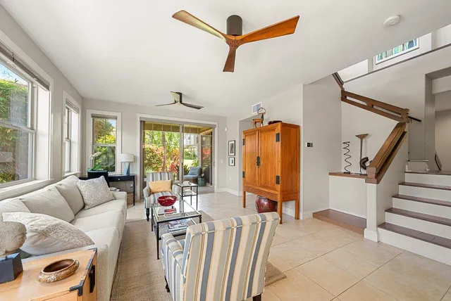 a living room with furniture ceiling fan and a rug