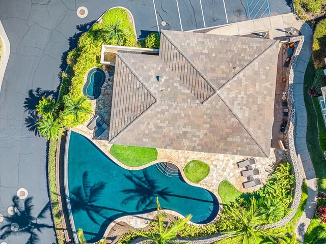 a view of house with swimming pool outdoor seating