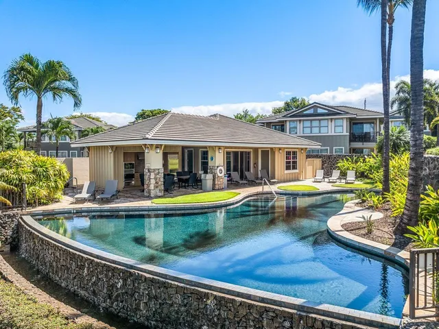 a swimming pool with outdoor seating and yard