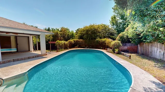 a swimming pool with wooden fence