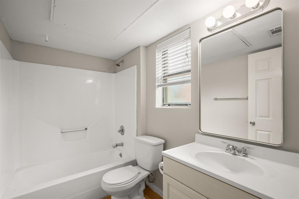 1013 West 23rd Street, Unit 104 Austin, TX 78705 - Photo 8 of 11 Full bathroom featuring vanity and shower combination