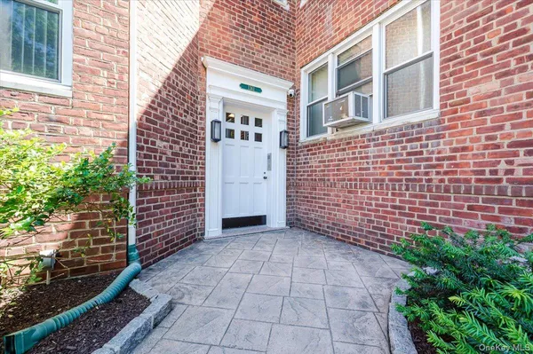 a view of a brick house with many windows