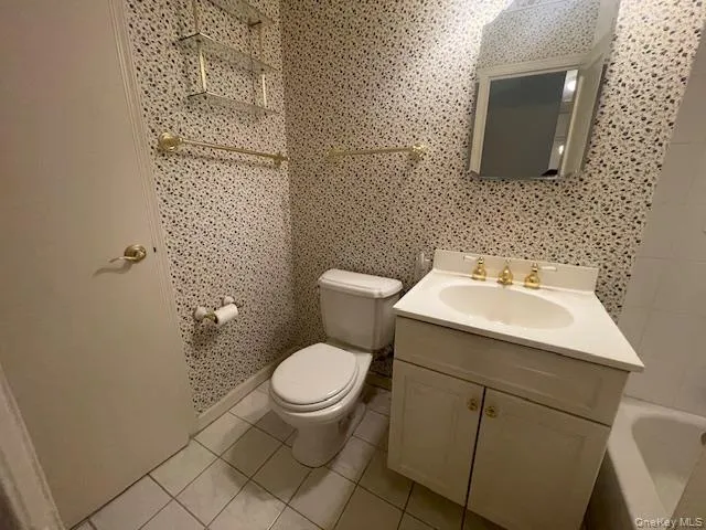 a bathroom with a sink toilet and a mirror