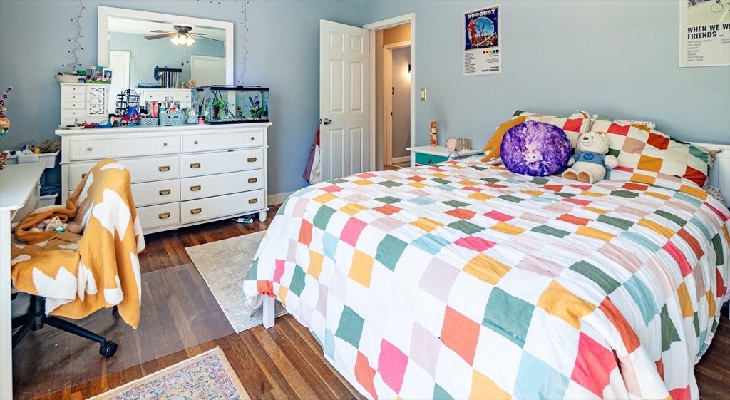 220 West Main Street Dudley, MA 01571 - Photo 21 of 42 a bedroom with a bed and wooden floor