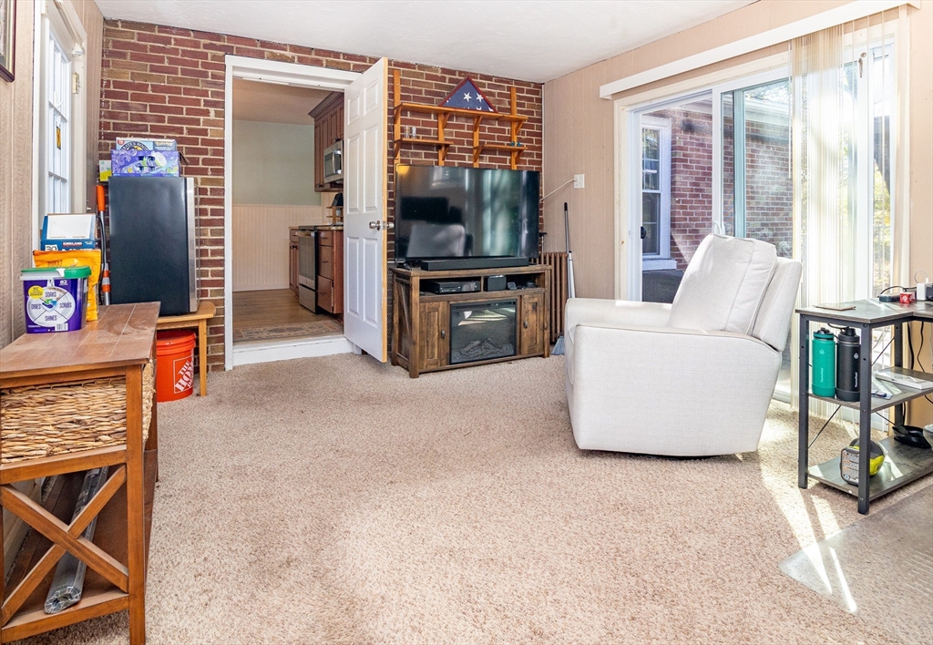 220 West Main Street Dudley, MA 01571 - Photo 27 of 42 a living room with furniture and a flat screen tv
