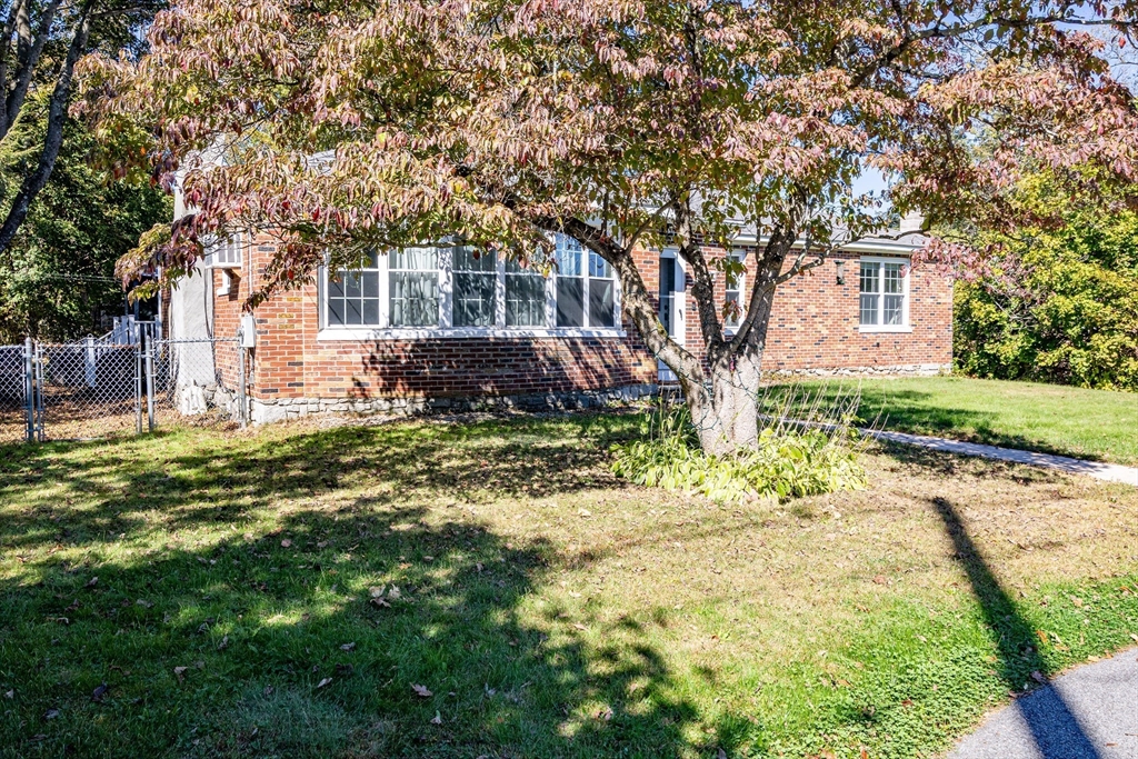 220 West Main Street Dudley, MA 01571 - Photo 41 of 42 a front view of a house with a garden and tree