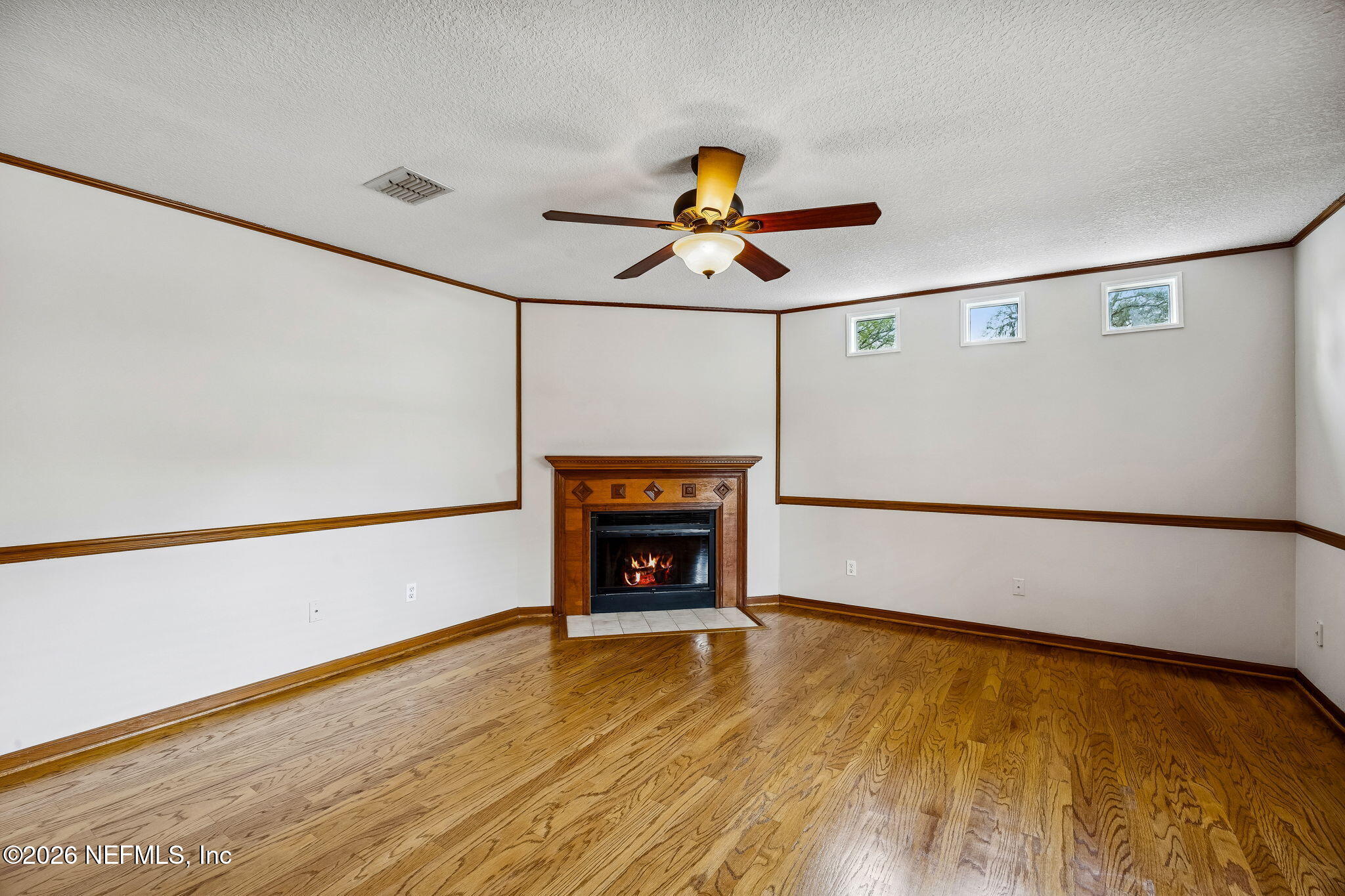 1888 Clemson Road Jacksonville, FL 32217 - Photo 39 of 41 a view of an empty room with wooden floor and a window