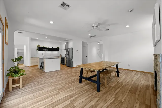 a living room with furniture and kitchen view