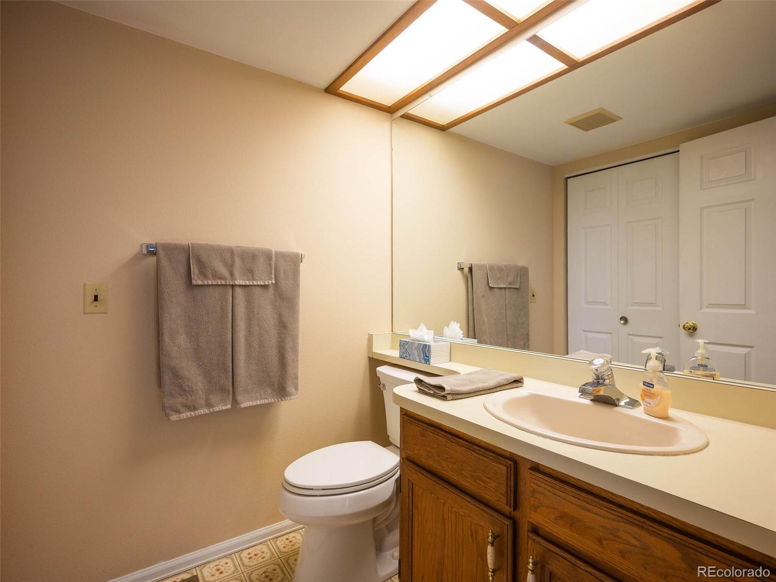 8634 Redstone Street Highlands Ranch, CO 80126 - Photo 13 of 25 a bathroom with a sink toilet and vanity