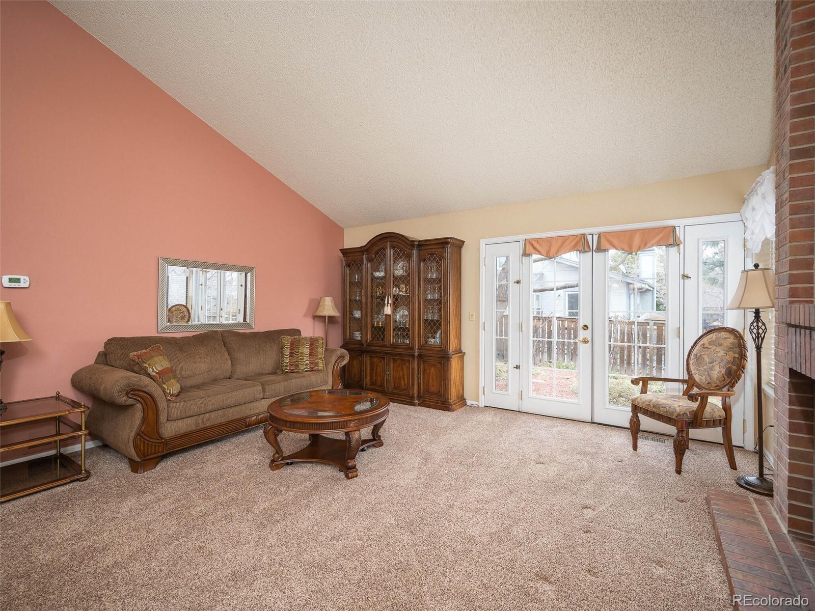 8634 Redstone Street Highlands Ranch, CO 80126 - Photo 8 of 25 a living room with furniture and a floor to ceiling window