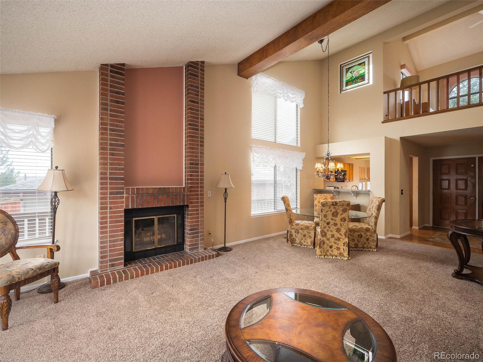 8634 Redstone Street Highlands Ranch, CO 80126 - Photo 9 of 25 a dining room with furniture and a fireplace