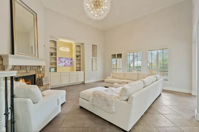 a living room with furniture and a chandelier