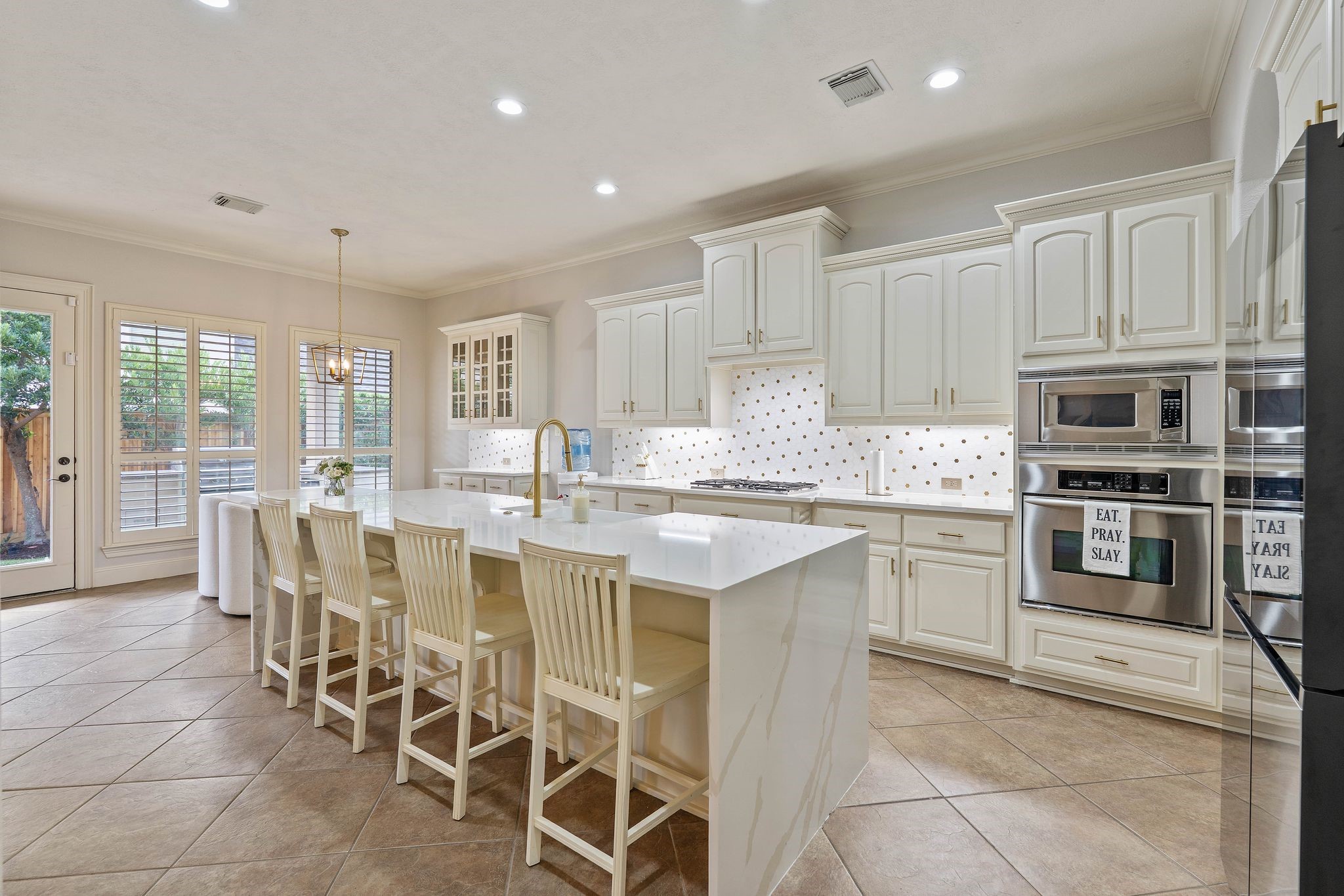7603 Hogan Bridge Court Spring, TX 77389 - Photo 18 of 49 a kitchen with stainless steel appliances granite countertop a stove top oven a sink a dining table and chairs