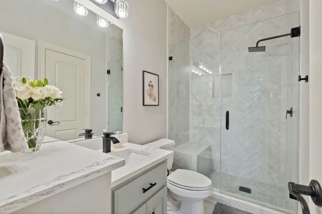 a bedroom with a bed a chandelier and a window