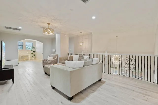 a living room with furniture and a wooden floor