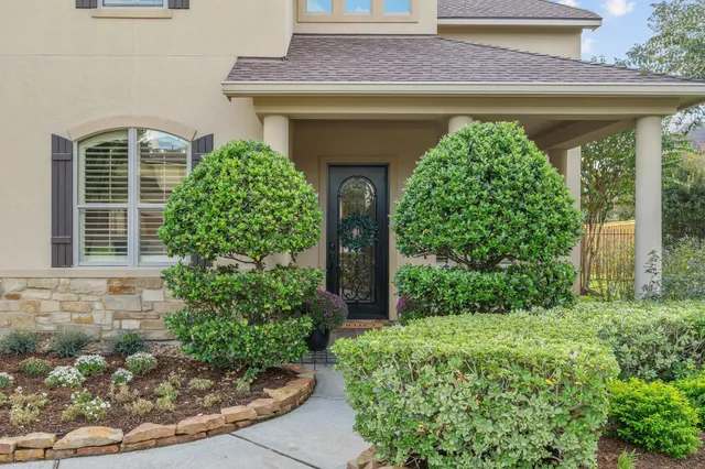 a front view of a house with garden