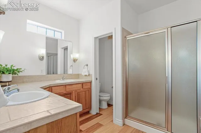 a bathroom with a granite countertop sink mirror and a bathtub
