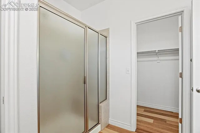 a bathroom with a glass shower door