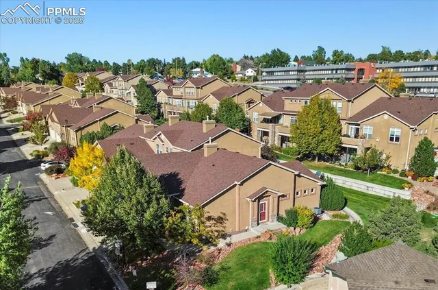 an aerial view of residential houses with outdoor space