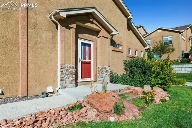 a front view of a house with garden