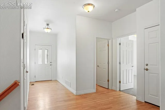 a view of a room with wooden floor and bathroom view