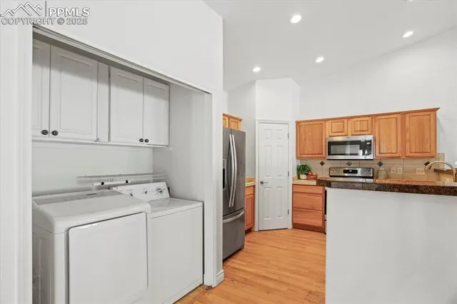 a kitchen with stainless steel appliances granite countertop a stove top oven a sink and a refrigerator